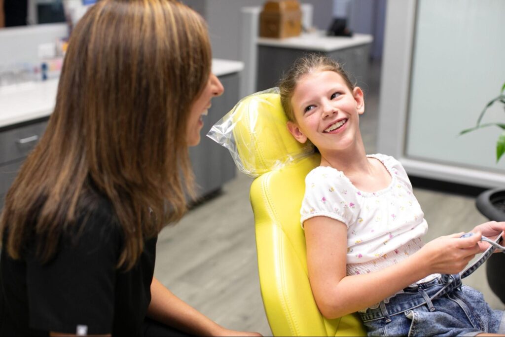 Luv Braces orthodontist with a young patient during an Austin orthodontics consultation