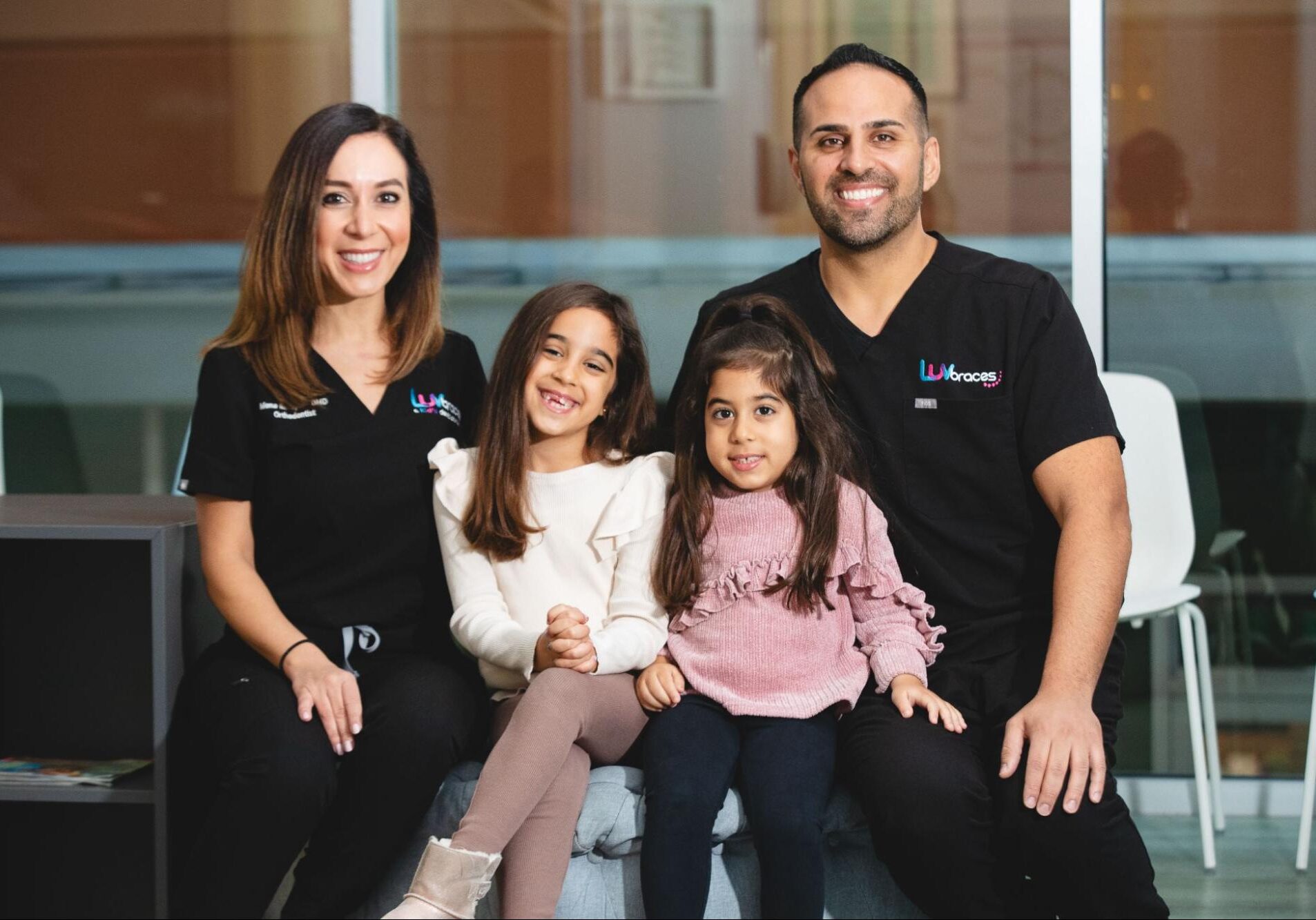 Smiling family with orthodontists at Luv Braces, showcasing friendly orthodontics in Austin and kids' dentistry services.