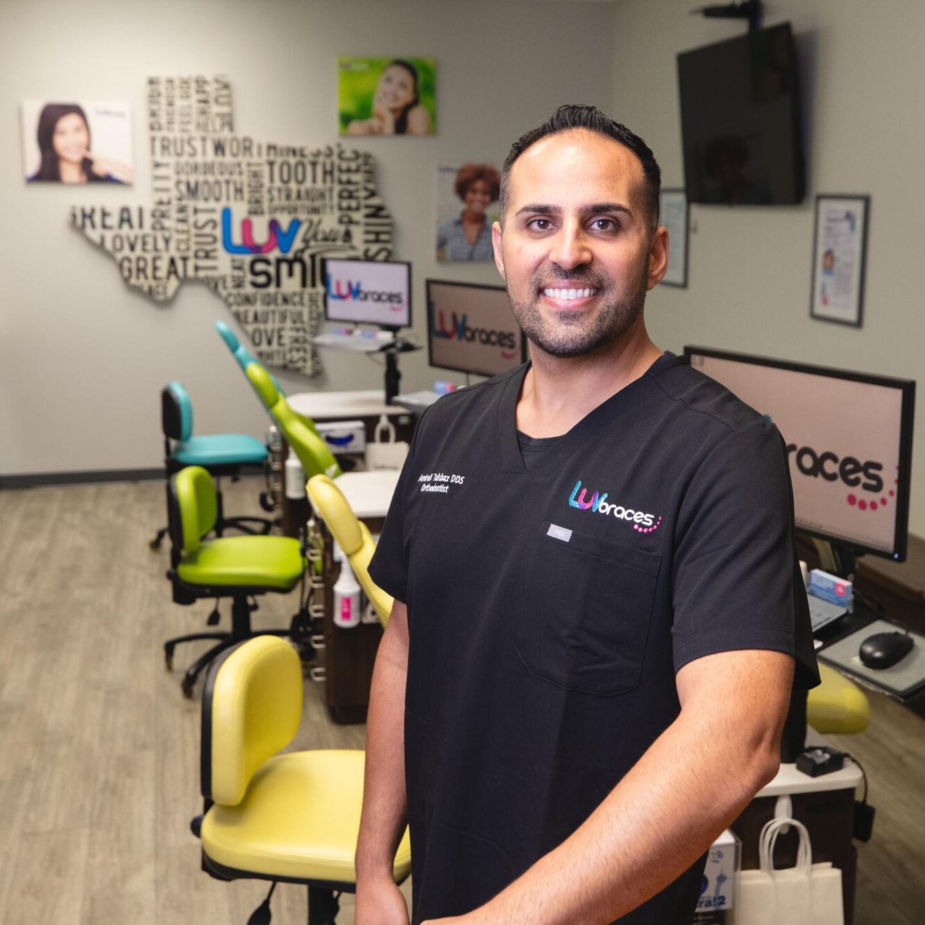 Orthodontist Dr. Amirali Tahbaz smiling in Luv Braces office, showcasing a welcoming environment for Austin orthodontics.