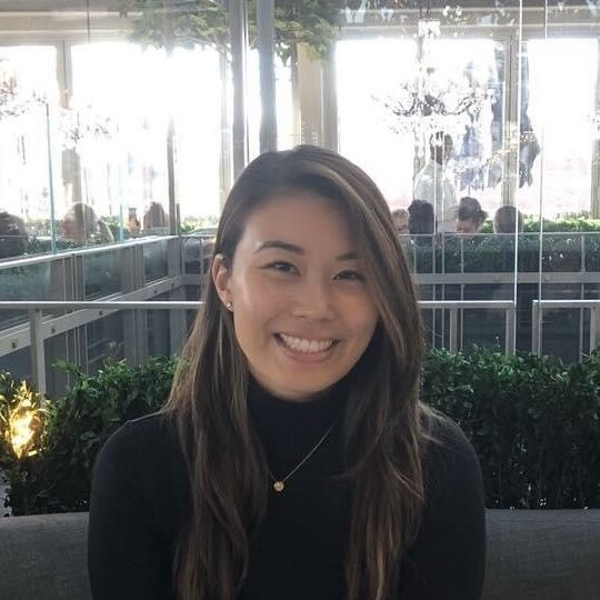 Smiling woman in a black top, representing a friendly atmosphere at an Austin orthodontics practice, promoting care and expertise.